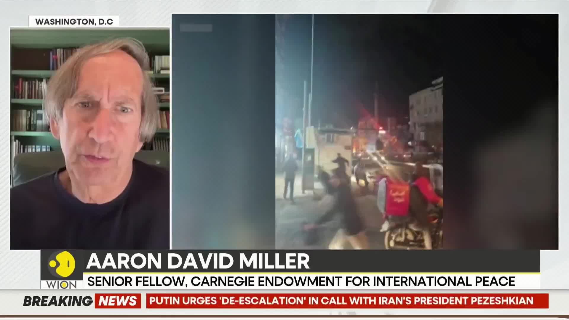 People are moving through a street at night, some on motorcycles, with red lights flashing in the background. A man in a red vest with Arabic lettering is visible on a scooter.