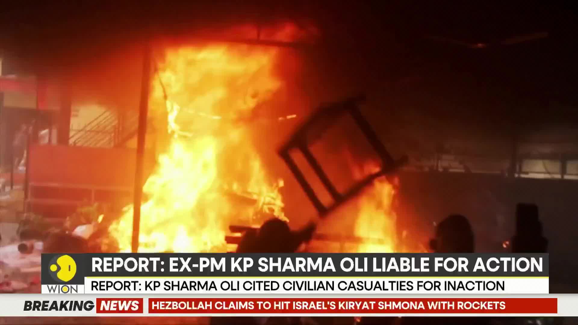 Flames engulf a structure, sending a chair tumbling through the inferno. Smoke billows into the night sky, obscuring the details of what's happening.