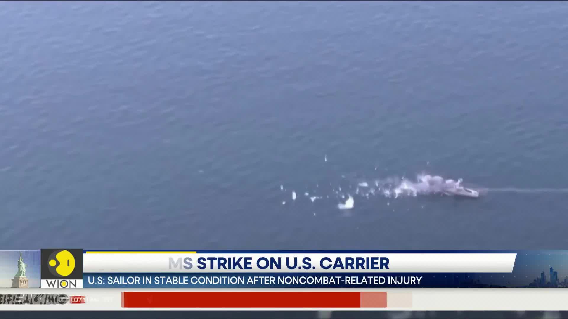 A ship cuts through the water, leaving a trail of white spray. On the screen, WION reports on a U.S. sailor's stable condition after an injury.