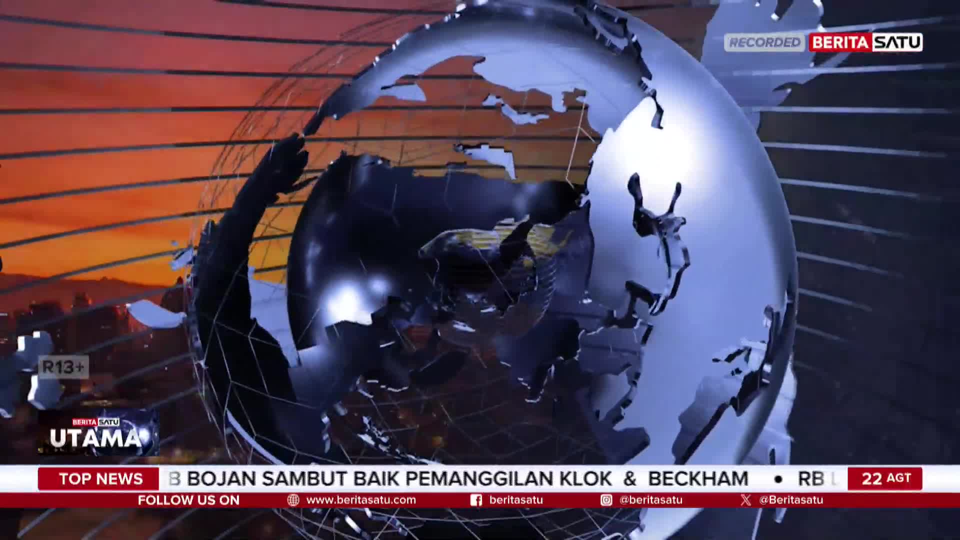 A metallic globe, segmented and reflecting light, slowly rotates against a backdrop of orange and red. The BeritaSatu English logo is visible, and the news ticker below highlights a story about Bojan.
