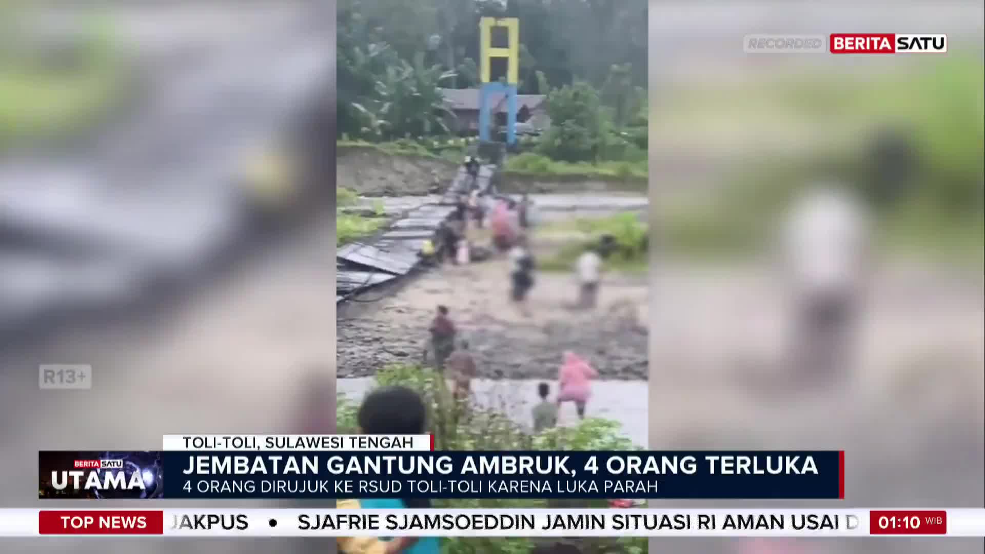 People are gathered on a damaged bridge, some helping others. The BeritaSatu English report from Indonesia shows the aftermath of a collapsed suspension bridge in Toli-Toli, Sulawesi Tengah.

