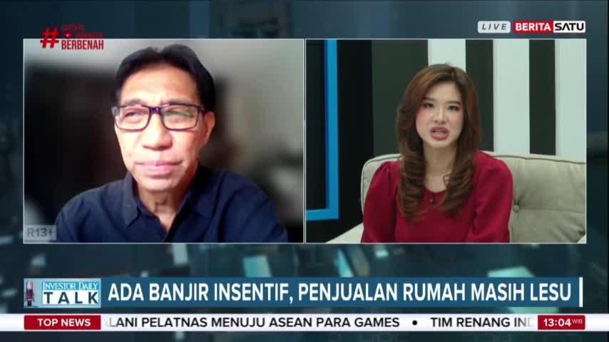 A man in glasses is on screen, while a woman in a red shirt speaks from a studio set. The BeritaSatu English broadcast is discussing incentives and home sales in Indonesia.
