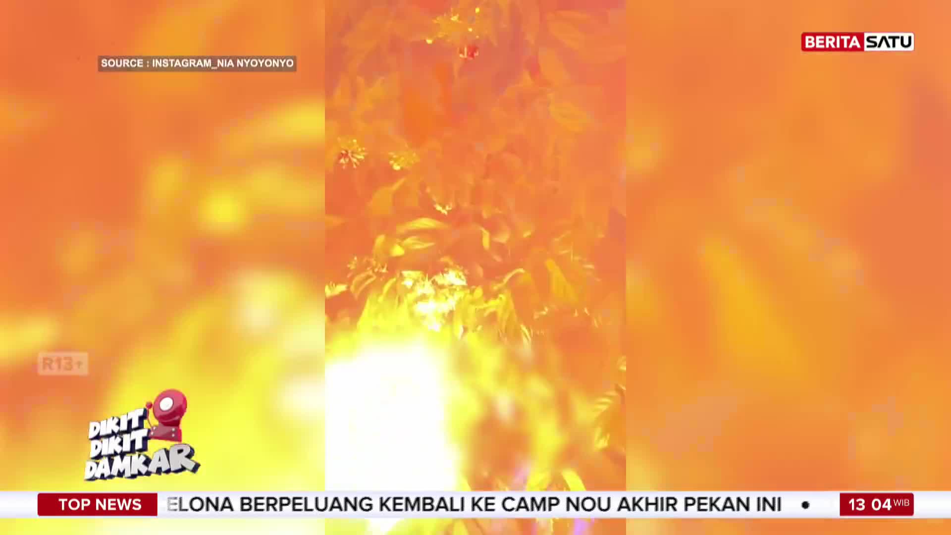 The screen shows a bright, fiery image, possibly from a fire, as reported by BeritaSatu English from Indonesia. The bottom of the screen displays news headlines.
