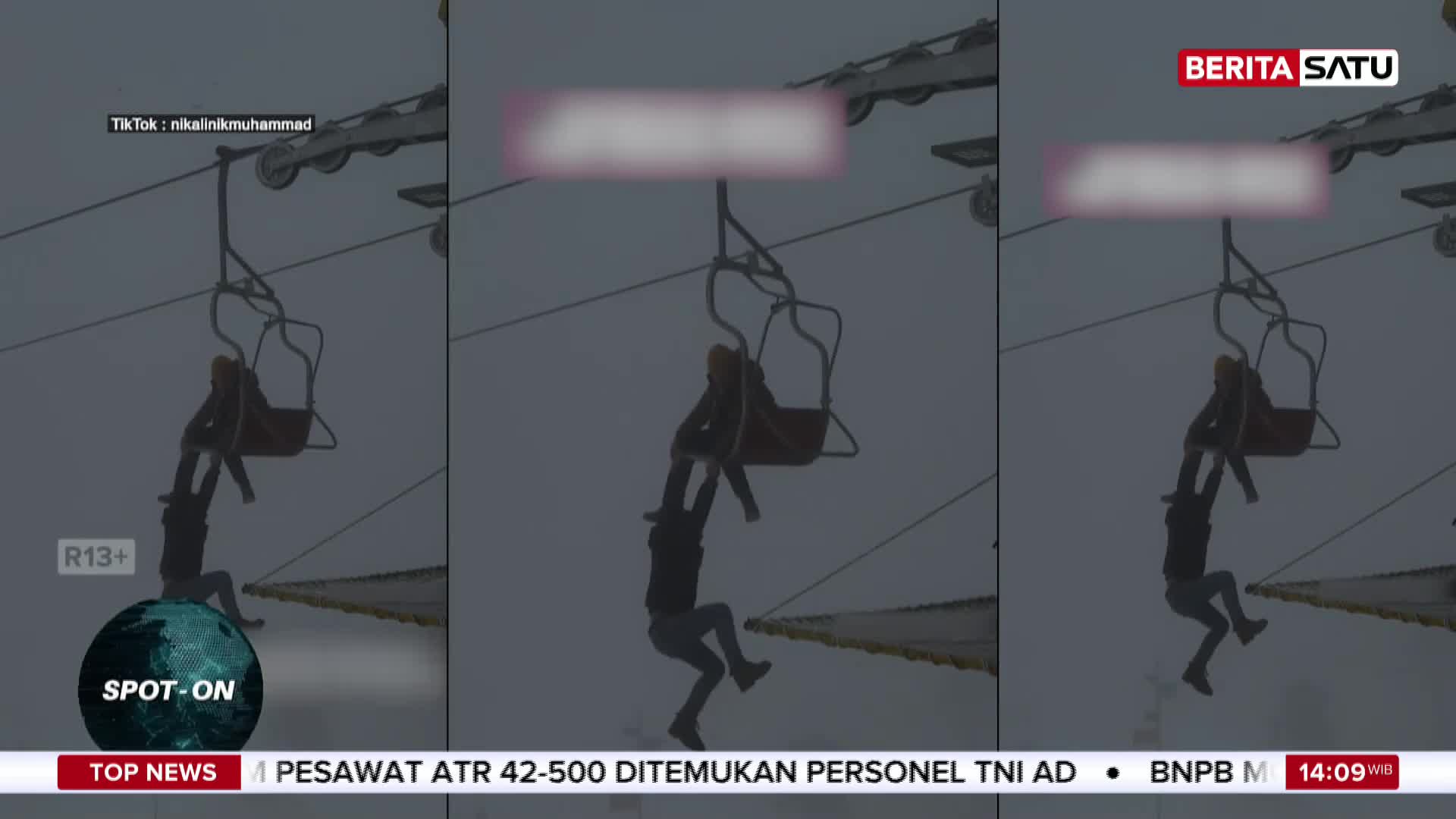 A person dangles precariously from a ski lift, held by another passenger. This dramatic scene, captured in Indonesia, is being reported by BeritaSatu. A person dangles precariously from a ski lift, held by another passenger. This dramatic scene, captured in Indonesia, is being reported by BeritaSatu.