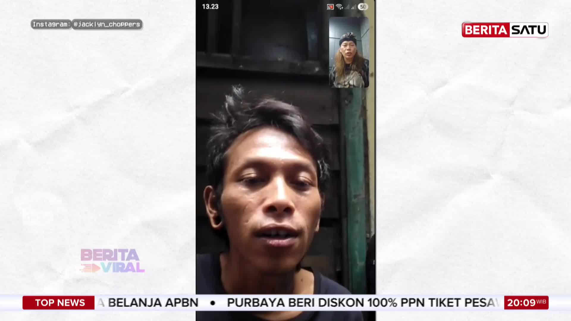 A man with dark, messy hair speaks directly to the camera, his mouth slightly open. In a small window above him, another man with longer hair and a beanie looks on. A Berita Satu logo appears in the corner of the screen.