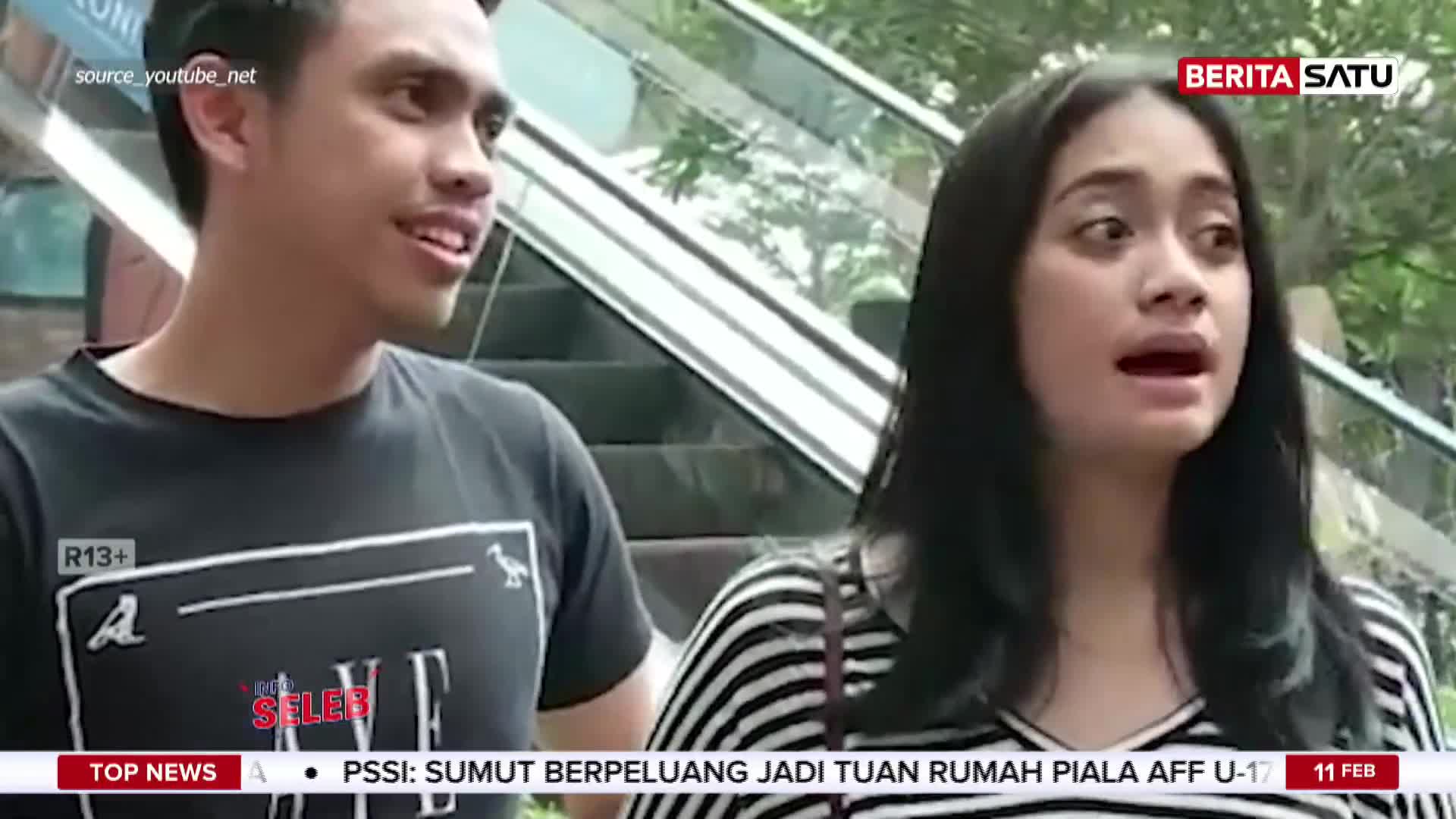 A young woman with a surprised expression speaks into a microphone, while a man beside her looks on. The BeritaSatu logo is visible in the corner, indicating this is a news report from Indonesia.