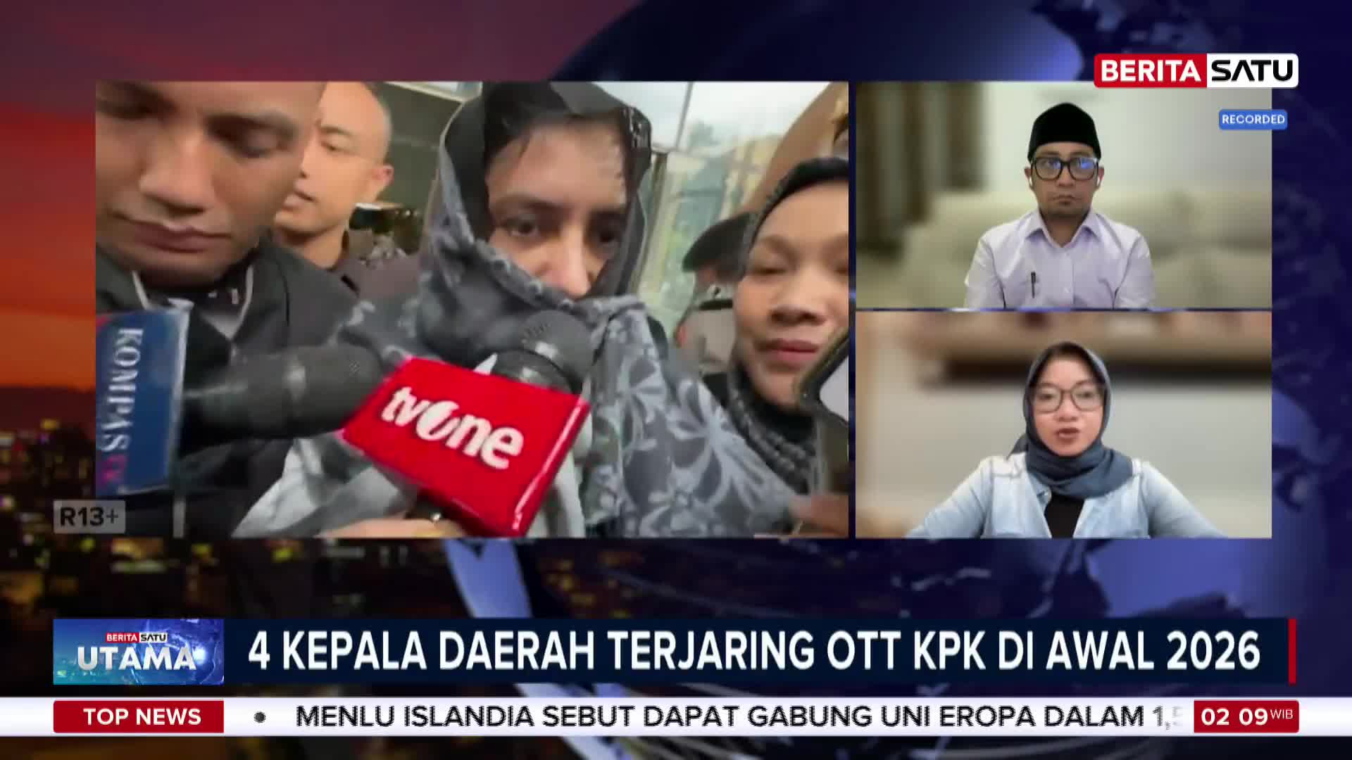A woman, partially obscured by a patterned scarf, is surrounded by microphones from Kompas and tvOne. Two individuals appear in separate video feeds on the right, one wearing a peci cap and the other a hijab.