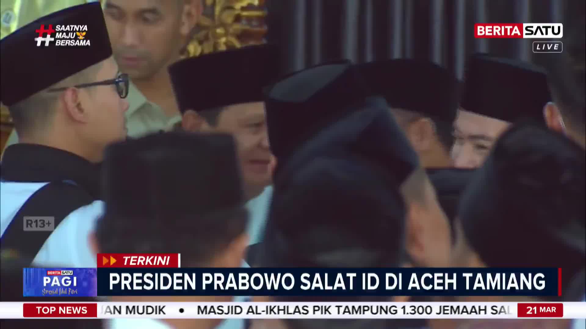 A group of men in black peci hats are gathered, some looking towards the camera. The BeritaSatu logo is visible in the upper right corner.