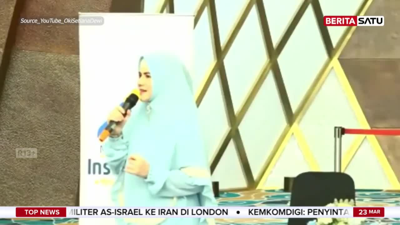 A woman in a light blue hijab speaks into a microphone, her voice amplified for the audience. A BeritaSatu logo is visible in the upper right corner.