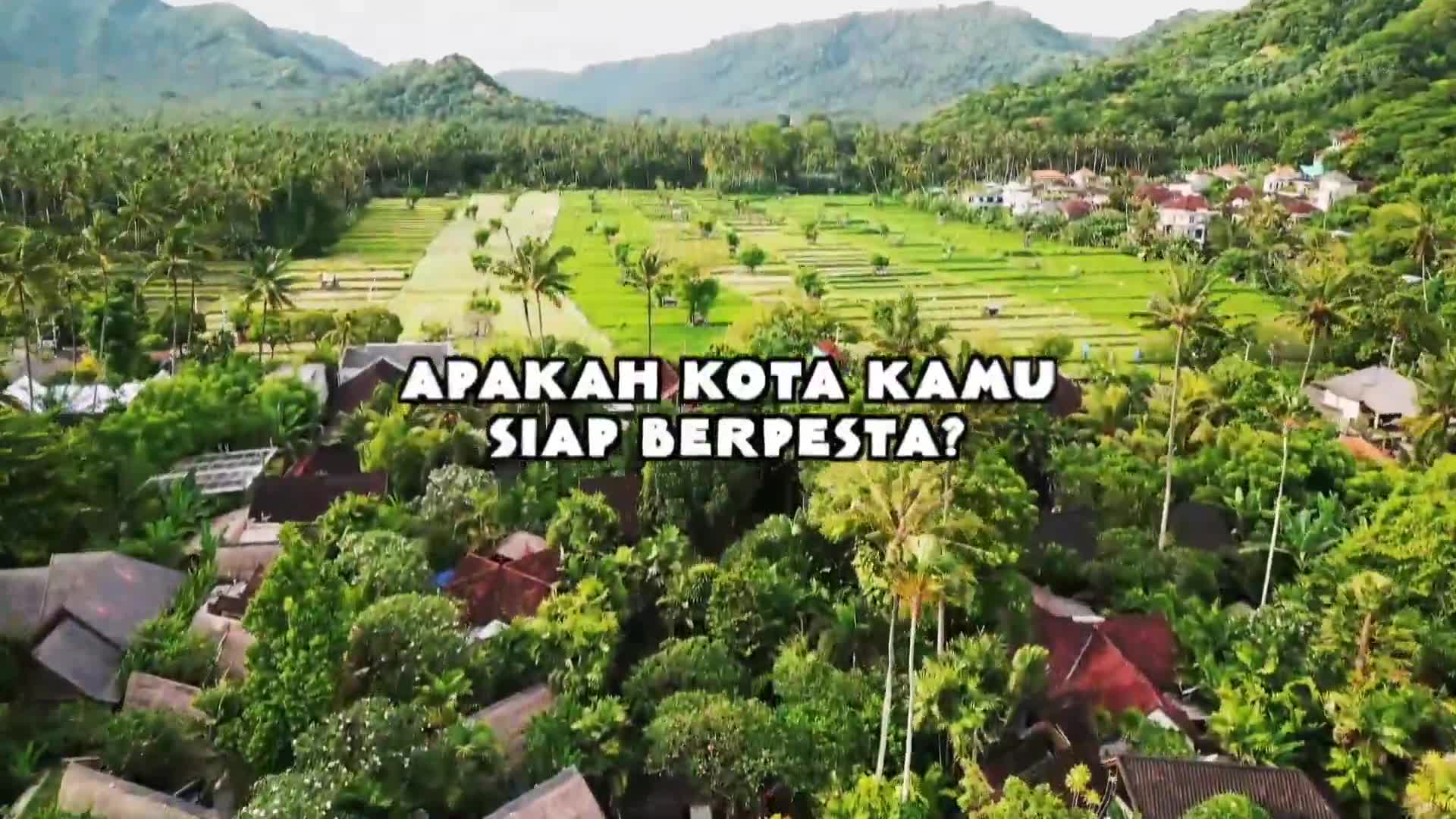 The lush green rice terraces stretch out towards a distant village nestled among palm trees.  A cluster of red-tiled roofs peeks through the dense foliage of the foreground.