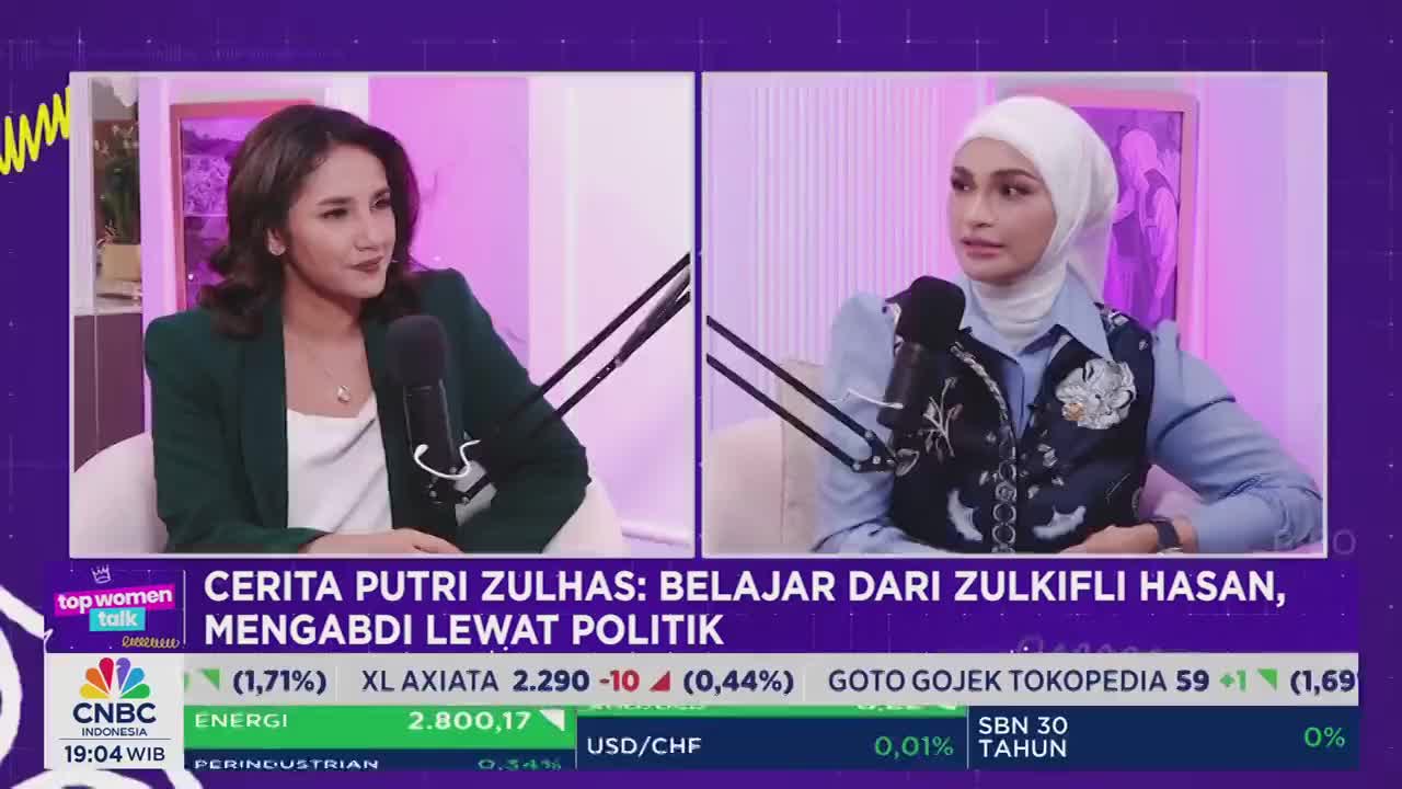 Two women sit facing each other in a split-screen interview on CNBC Indonesia's "Top Women Talk." The chyron displays financial data and the program's topic, "The Story of Putri Zulhas: Learning from Zulkifli Hasan, Serving Through Politics."
