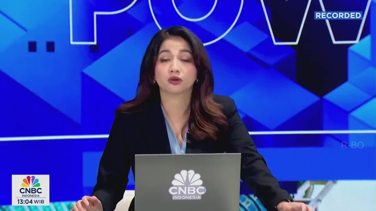 A woman in a dark blazer speaks directly to the camera, her hands resting on a laptop bearing the CNBC Indonesia logo. The broadcast is marked as "recorded" at the top of the screen.
