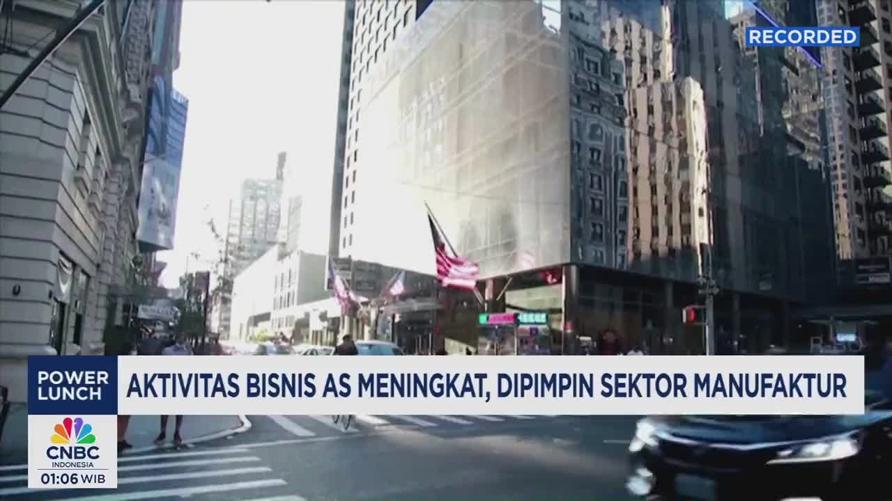 Across the street, pedestrians cross a wide avenue, while cars move in the opposite direction. The CNBC Indonesia banner at the bottom of the screen reports on business activity.
