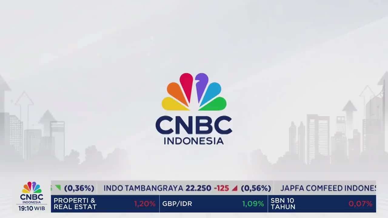 The CNBC Indonesia logo, a burst of color, is centered on a light background. Below, a ticker displays financial data, including stock prices and percentages.

