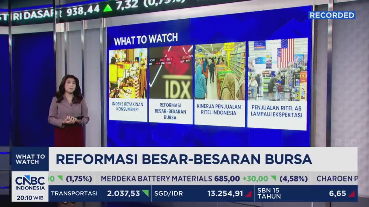 A woman stands in front of a screen displaying stock market data and images related to Indonesian business. The CNBC Indonesia logo is visible at the bottom left.