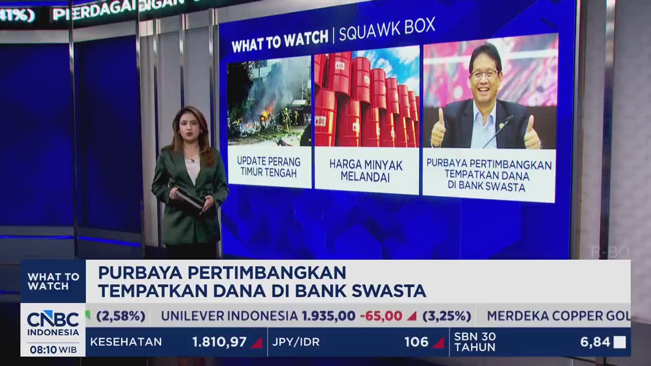 A woman in a green blazer stands on a studio set, holding a tablet. Behind her, a large screen displays three panels: one with flames and smoke, another with stacked red oil drums, and the third with a man giving a thumbs-up. The CNBC Indonesia logo is visible at the bottom left. A woman in a green blazer stands on a studio set, holding a tablet. Behind her, a large screen displays three panels: one with flames and smoke, another with stacked red oil drums, and the third with a man giving a thumbs-up. The CNBC Indonesia logo is visible at the bottom left.