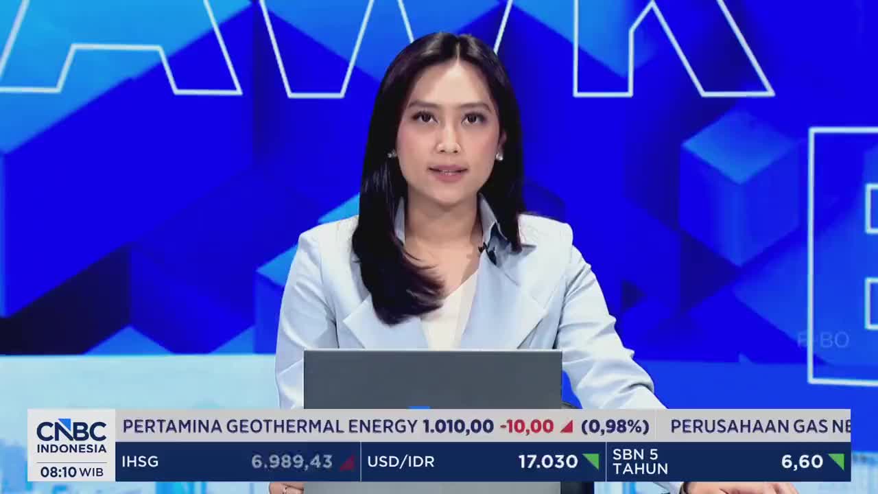 A woman in a light blue blazer speaks directly to the camera, her gaze steady. Below her, a ticker displays market data from CNBC Indonesia, showing stock prices and currency exchange rates. A woman in a light blue blazer speaks directly to the camera, her gaze steady. Below her, a ticker displays market data from CNBC Indonesia, showing stock prices and currency exchange rates.
