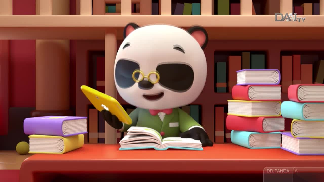 Dr. Panda, from DAAI TV in Indonesia, is sitting at a desk, reading a book and holding a tablet. Stacks of colorful books sit on either side of him, and bookshelves fill the background.

