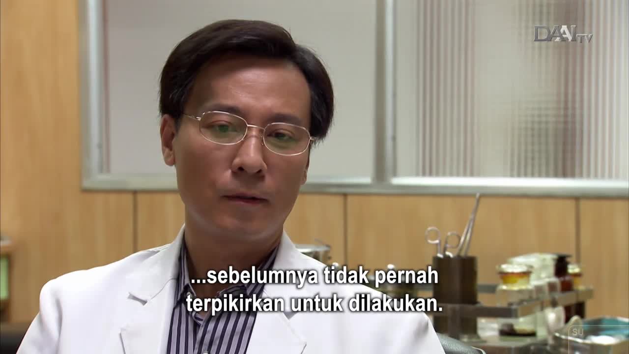 A man in a white doctor's coat speaks directly to the camera, his glasses reflecting the light. Behind him, medical instruments rest on a counter, a subtle reminder of the DAAI TV broadcast from Indonesia. A man in a white doctor's coat speaks directly to the camera, his glasses reflecting the light. Behind him, medical instruments rest on a counter, a subtle reminder of the DAAI TV broadcast from Indonesia.