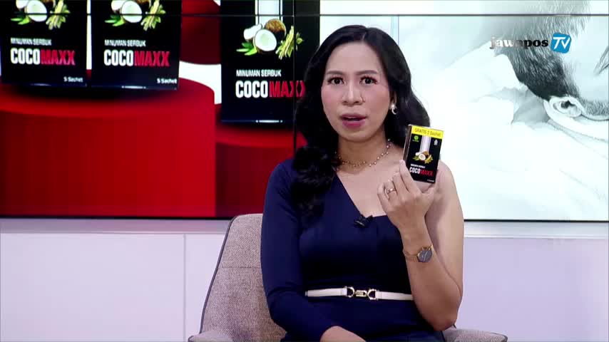 On Jawa Pos TV, a woman in a blue dress holds a small box of CocoMaxx, gesturing toward the camera. Behind her, a screen displays the CocoMaxx packaging and the Jawa Pos TV logo.
