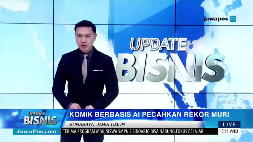 A man in a suit stands in front of a blue background, speaking on Jawa Pos TV's "Update Bisnis" segment. The lower third announces a story about an AI-based comic breaking a record in Surabaya, East Java.
