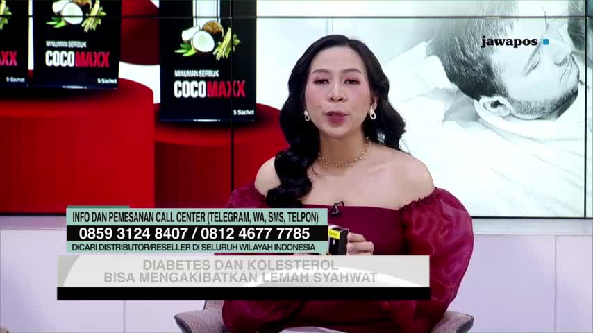 A woman in a maroon dress is speaking on Jawa Pos TV, with a product called CocoMaxx visible behind her. Text at the bottom of the screen warns about the effects of diabetes and cholesterol.

