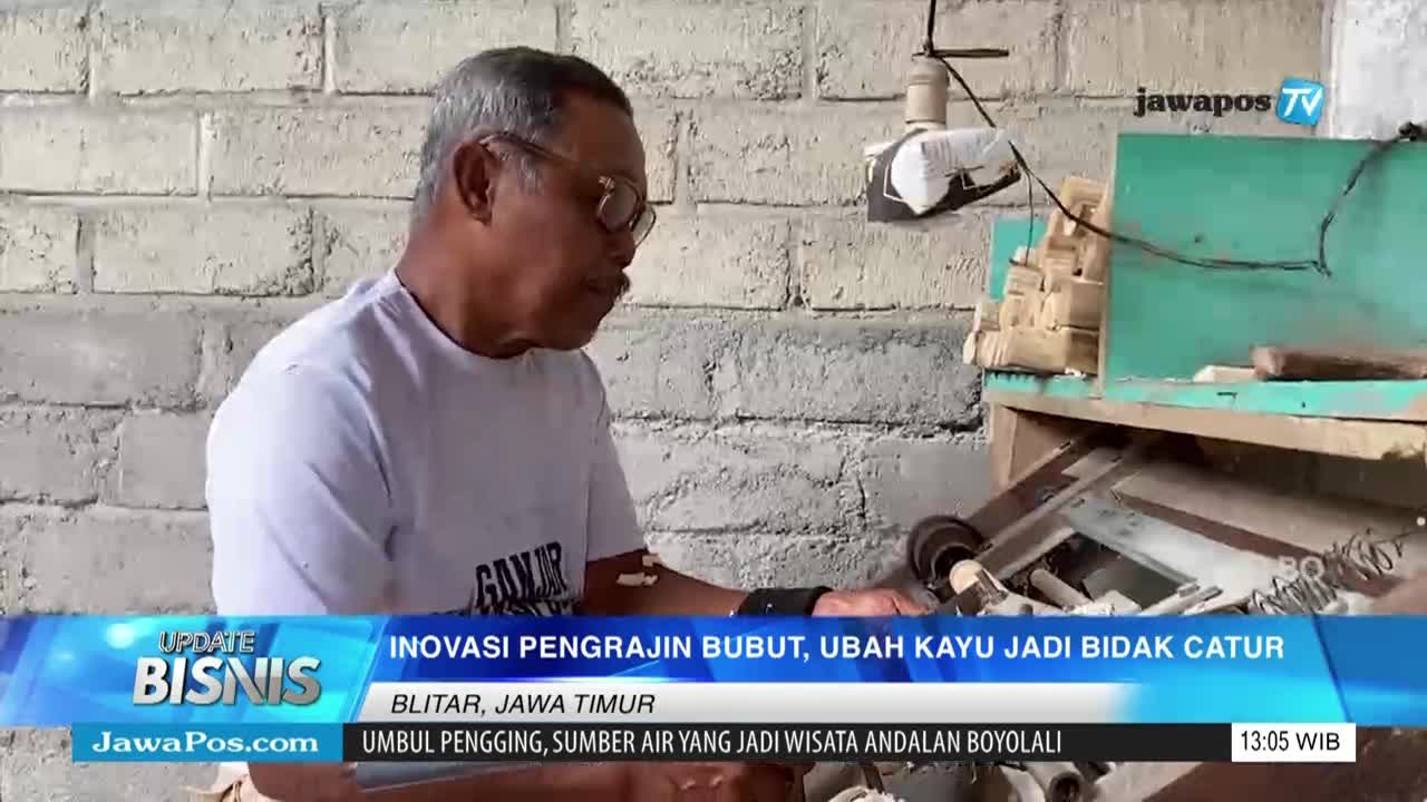 A man in glasses works at a wooden workbench, likely crafting chess pieces, as the Jawa Pos TV logo appears in the corner. The screen shows text about innovation in Blitar, East Java.
A man in glasses works at a wooden workbench, likely crafting chess pieces, as the Jawa Pos TV logo appears in the corner. The screen shows text about innovation in Blitar, East Java.
