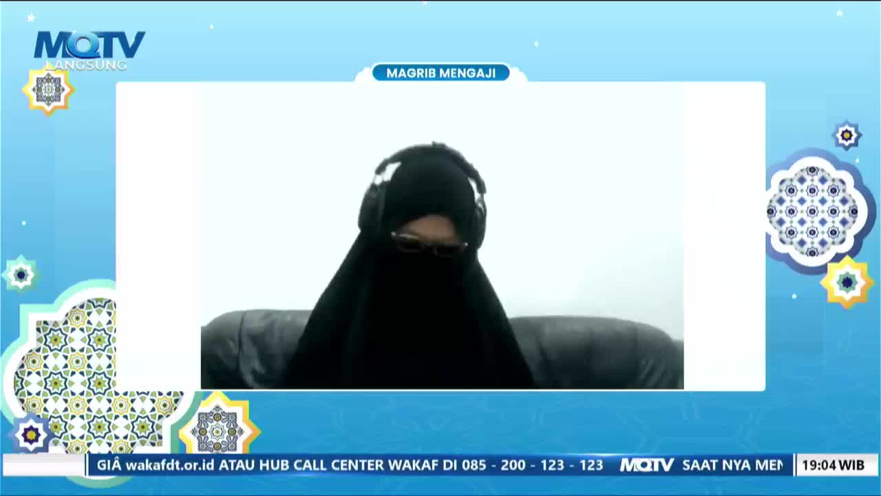 A person wearing a black niqab and headphones sits in front of a screen, framed by a blue background with decorative elements. The MQTV logo and "Magrib Mengaji" text suggest a religious broadcast from Indonesia.
