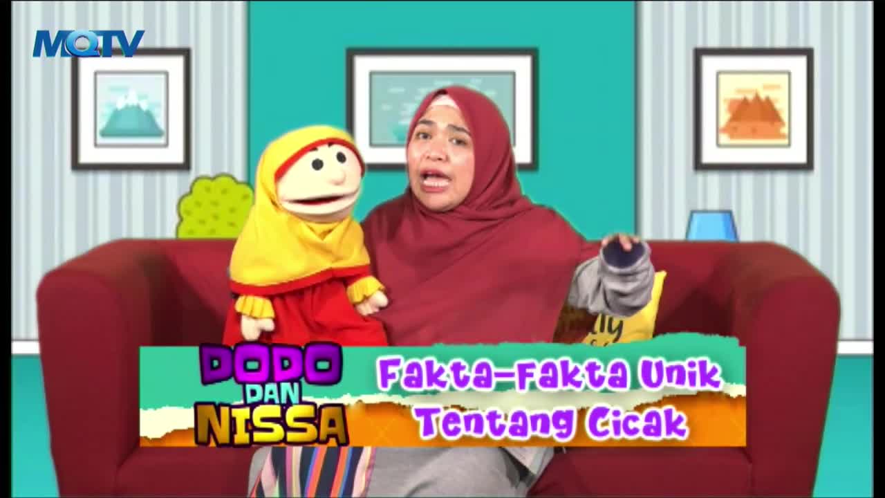 On a red couch, a woman in a maroon hijab gestures animatedly while a puppet in a yellow head covering sits beside her. The MQTV logo is visible, and the show's title card promises "Unique Facts About Geckos."
