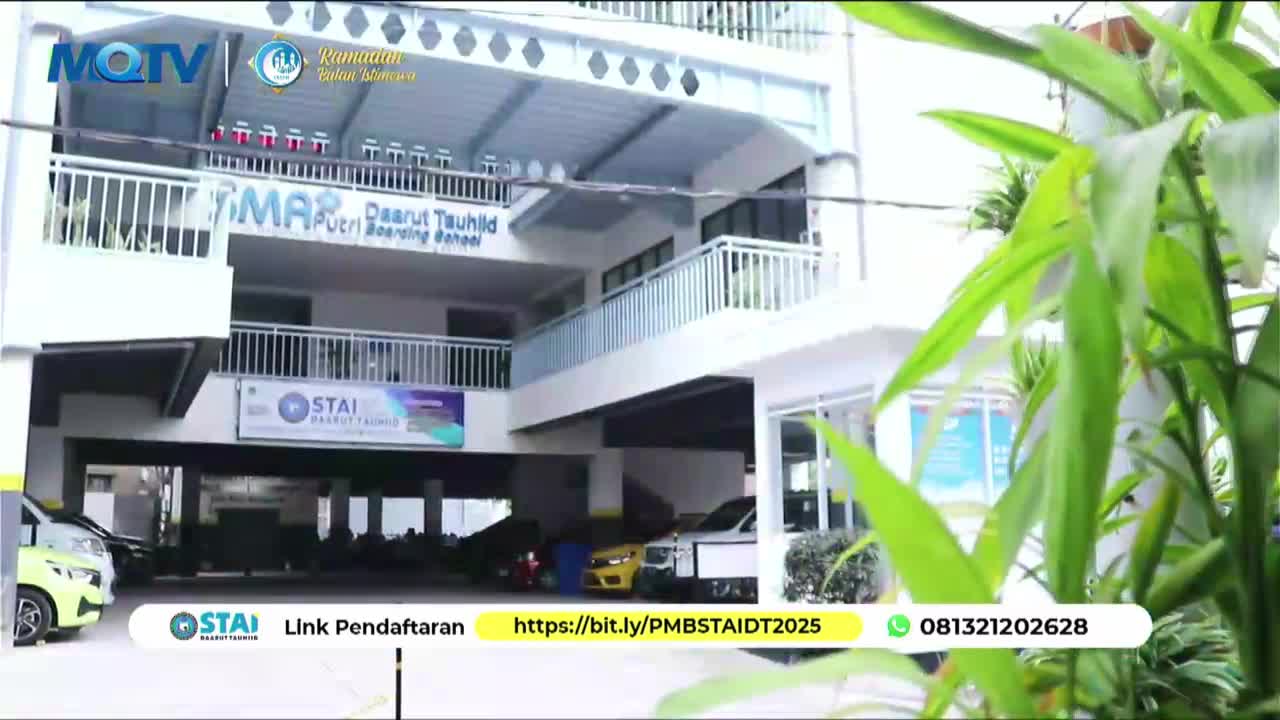 Cars are parked under a building with "SMA Putri Darut Tauhid Boarding School" written on it. A bright yellow car is visible in the middle of the parking area.