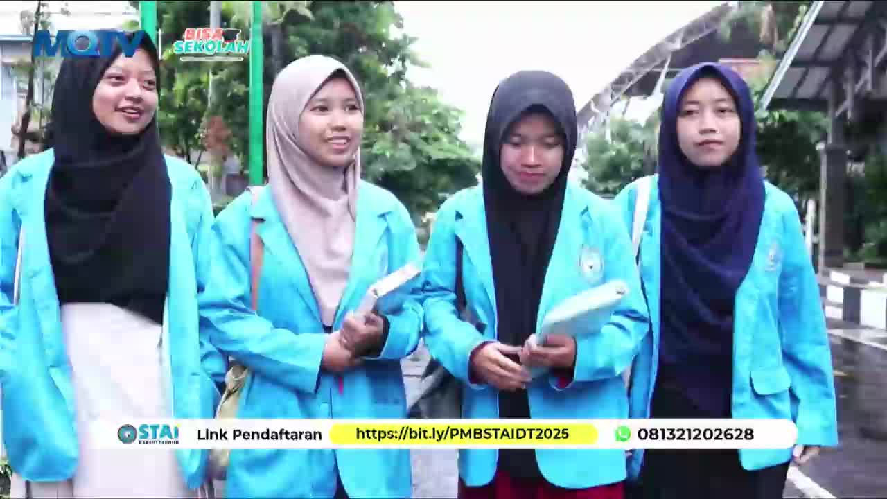 Four young women in light blue jackets and headscarves walk together, each holding a book. They appear to be students at an Indonesian institution, possibly filmed for MQTV.