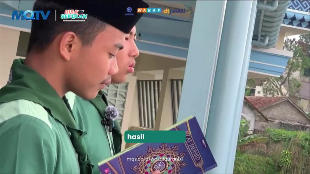Two young men in green uniforms stand close, one holding a book with Arabic script. The MQTV logo is visible in the upper left corner.