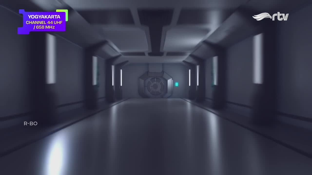 A long, metallic corridor stretches into the distance, with a large, circular door at the end. The Rajawali TV logo is in the corner, and the Yogyakarta channel information is displayed at the top left.
