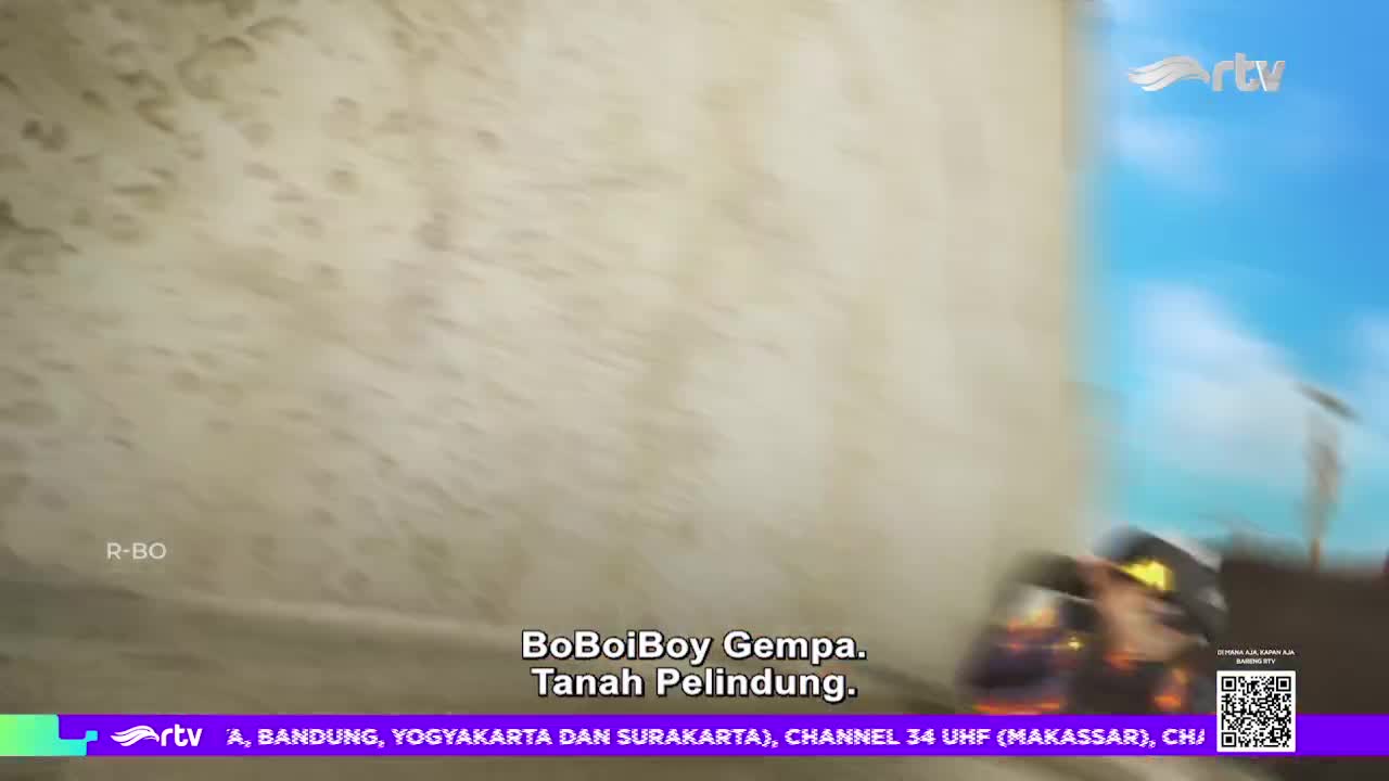 The animated character, BoBoiBoy Gempa, is speeding across the screen on Rajawali TV.  The Indonesian channel's logo is visible in the corner as the cartoon continues.
