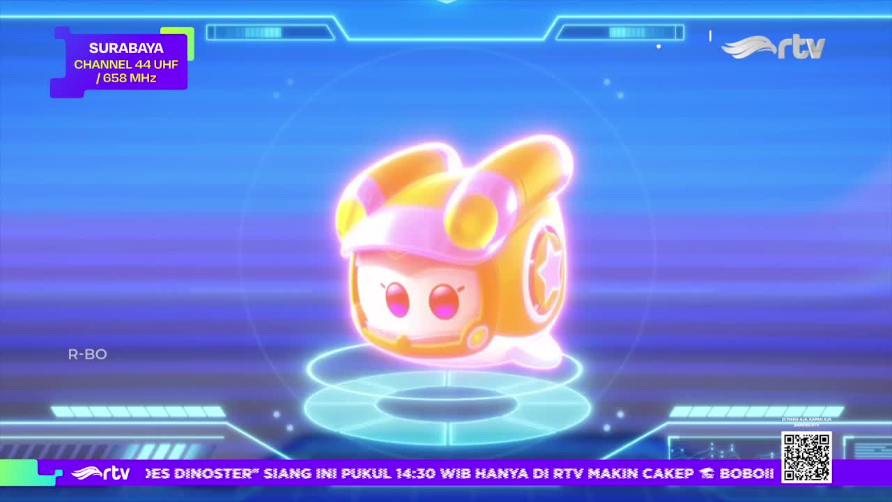 A cartoon character in a helmet and star emblem hovers in a glowing circle. The Rajawali TV logo is visible in the corner, and the Surabaya channel information is displayed above.
