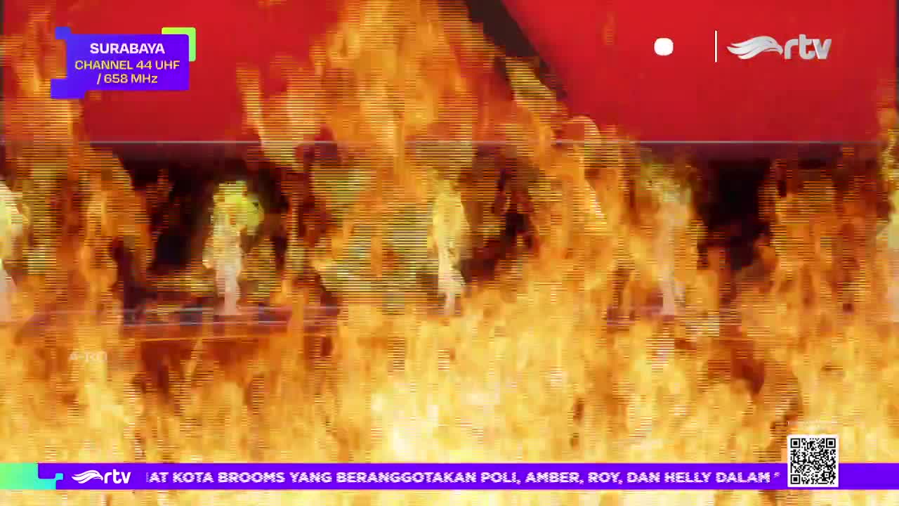 Flames erupt across the screen, obscuring the image beneath, as the Rajawali TV logo and Surabaya channel information remain visible. The bottom banner, with the rtv logo, advertises a show about "Kota Brooms".
