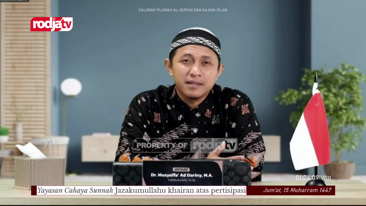 A man in a patterned shirt, wearing a cap, speaks directly to the camera on Rodja TV. The Indonesian flag stands to his right, and a small sign identifies him as Dr. Musyaffa' Ad Dariny.

