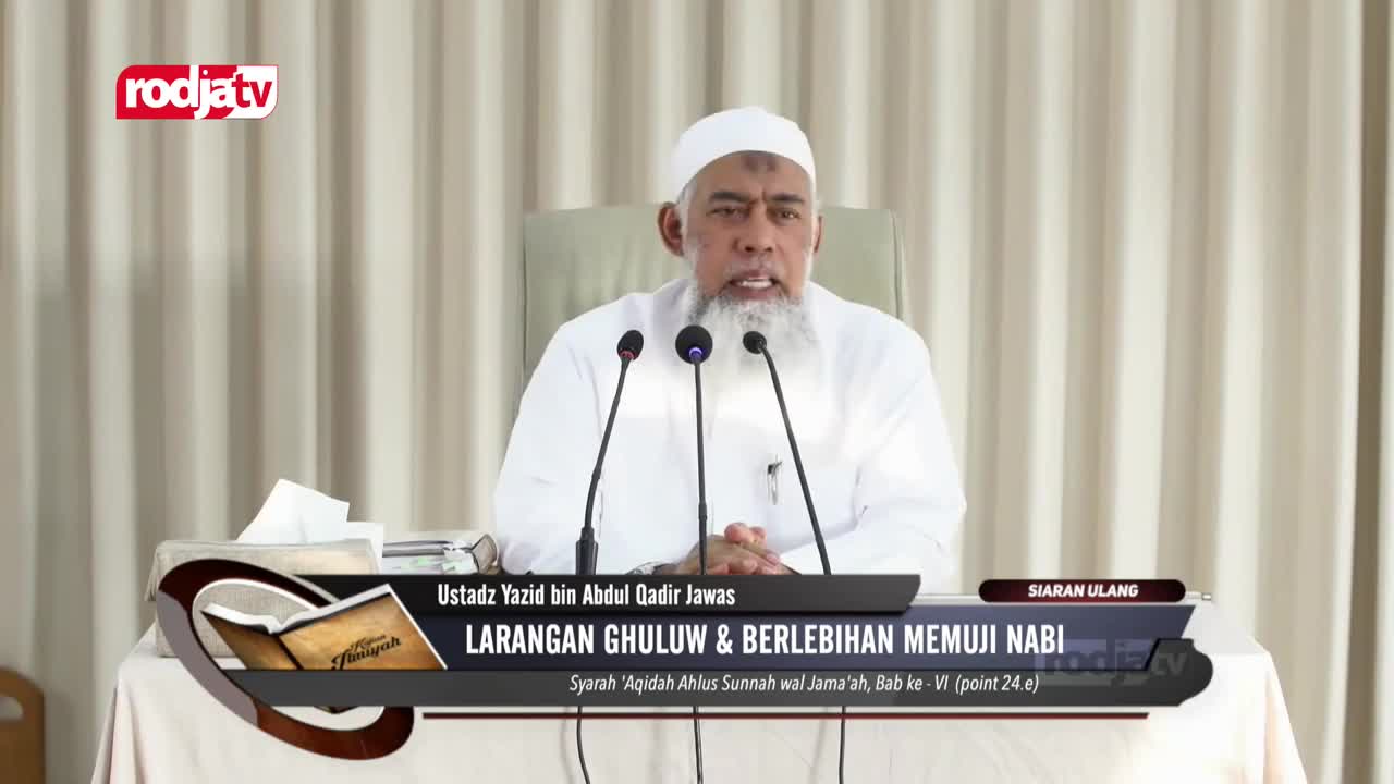 A man in a white cap and beard speaks into a microphone, with the Rodja TV logo visible in the corner. The screen displays a title about praising the prophet.
