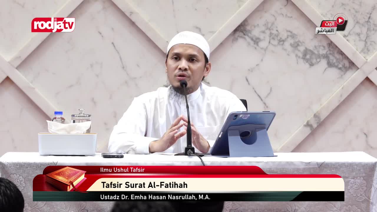 A man in a white cap and shirt speaks into a microphone, his hands clasped in front of him. The Rodja TV logo is visible in the corner, and a banner identifies the topic as "Tafsir Surat Al-Fatihah."

