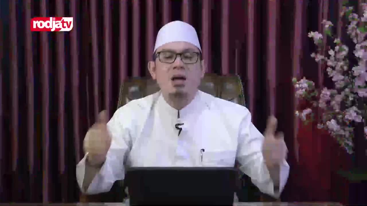 A man in a white peci and robe speaks animatedly, gesturing with both hands. The Rodja TV logo appears in the top left corner. A man in a white peci and robe speaks animatedly, gesturing with both hands. The Rodja TV logo appears in the top left corner.