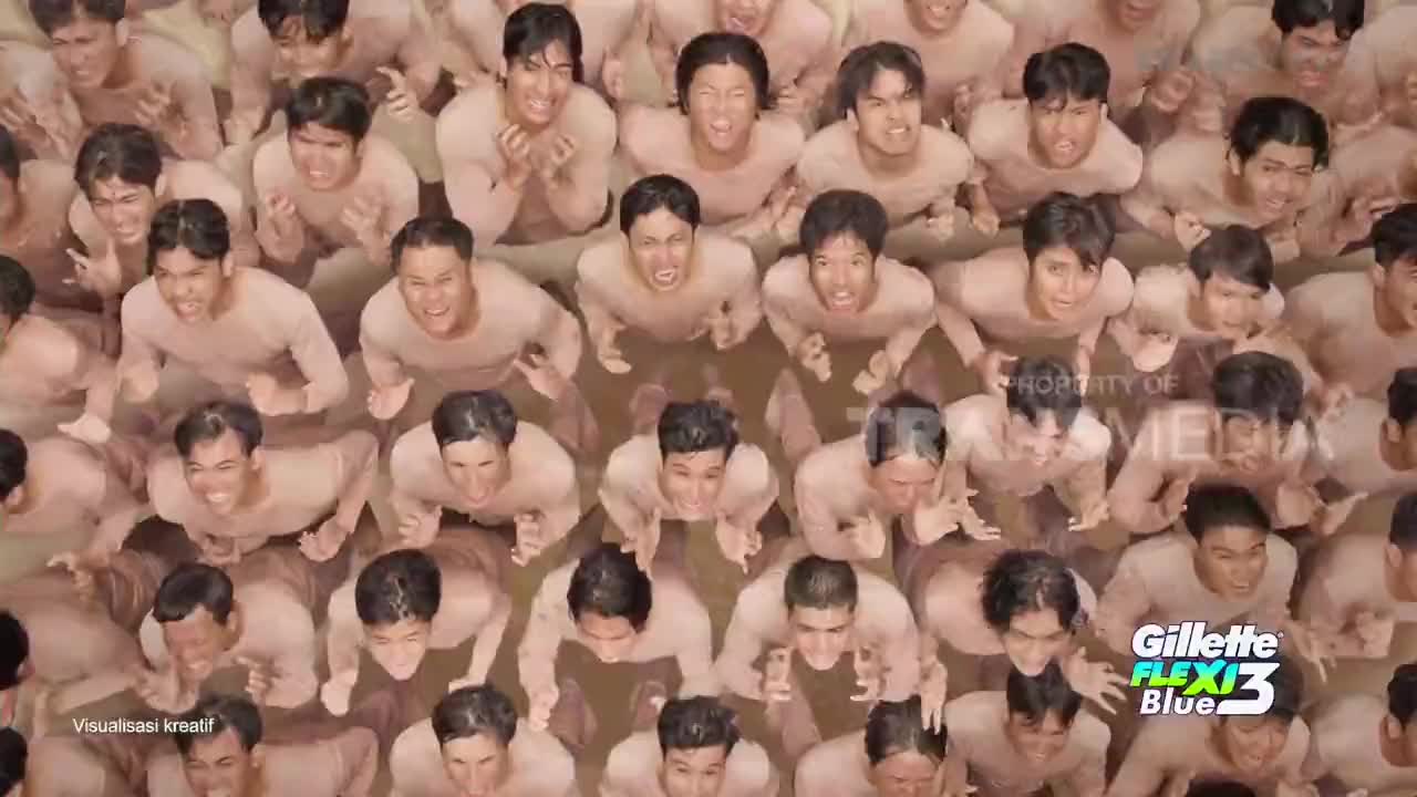 A sea of men, all with their arms raised, are looking up with expressions of intense emotion. The Gillette Flexi3 Blue logo is visible, suggesting this is a creative visual from Indonesia, possibly a commercial on Trans TV.
