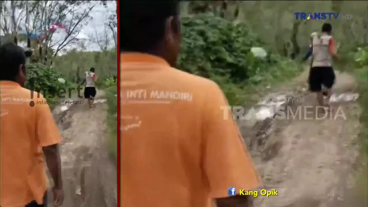 A man in shorts and a tank top runs barefoot down a muddy path. The camera follows from behind, with the "TRANS TV" logo visible in the corner.
