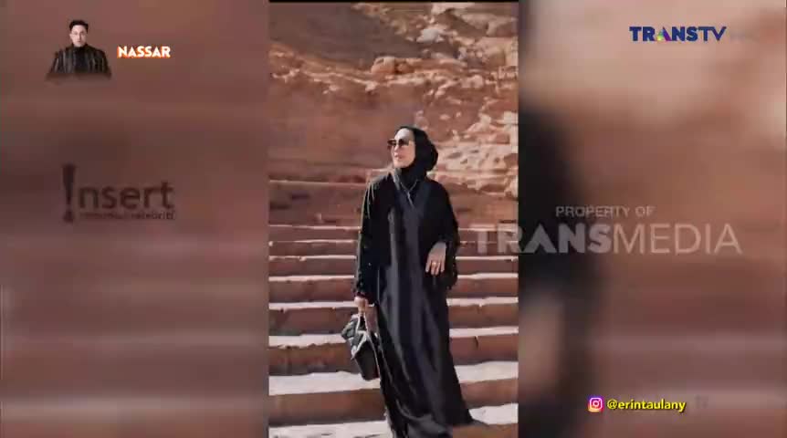 A woman in a black headscarf and dress poses on stone steps, holding a purse. The Trans TV logo is in the corner, and a graphic with Nassar's name is in the top left.
A woman in a black headscarf and dress poses on stone steps, holding a purse. The Trans TV logo is in the corner, and a graphic with Nassar's name is in the top left.