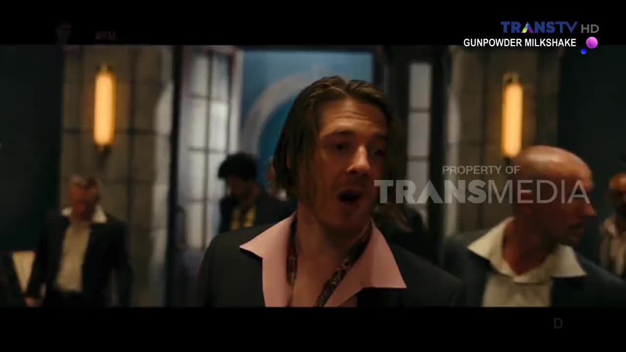 A man in a pink shirt and black suit is speaking, mouth open, looking surprised. Other men in suits stand around him in what looks like a dimly lit room, with the Trans TV logo visible in the corner.
A man in a pink shirt and black suit is speaking, mouth open, looking surprised. Other men in suits stand around him in what looks like a dimly lit room, with the Trans TV logo visible in the corner.