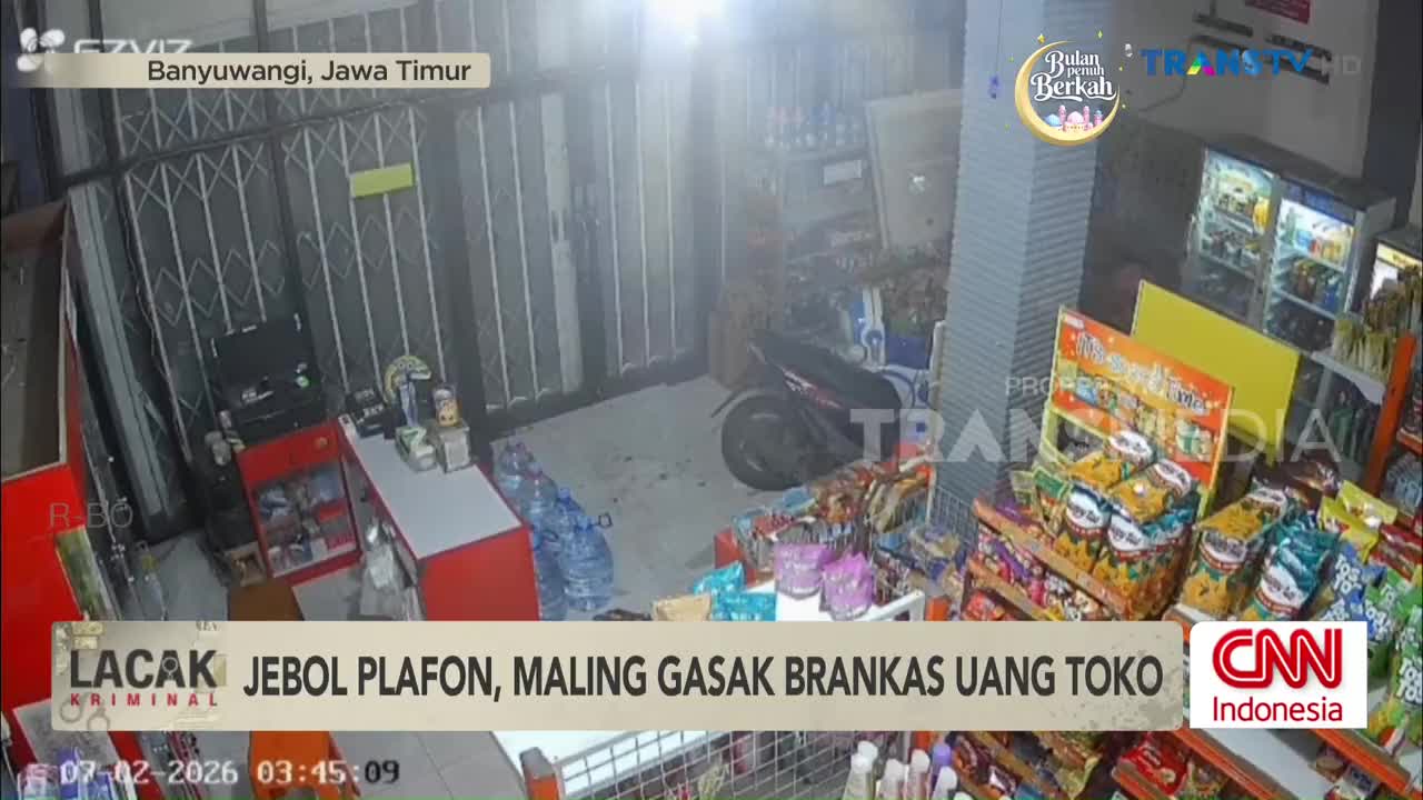 The ceiling above the shop is broken, and a thief has made off with the cash register. A motorcycle is parked near the back, and shelves are stocked with snacks and drinks.