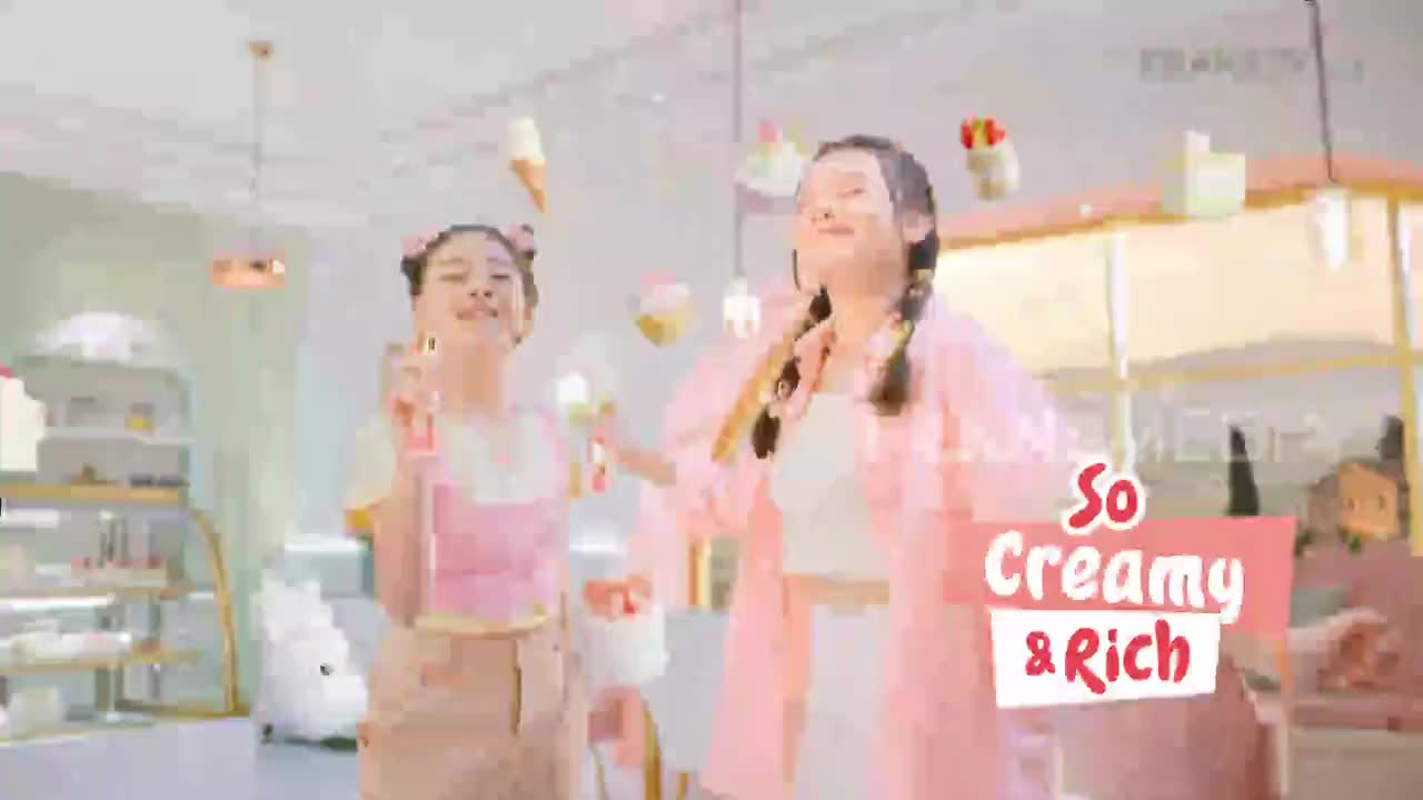 Two young women in pastel outfits dance as ice cream cones and cupcakes float around them in a brightly lit shop. A pink banner with "So Creamy & Rich" hovers in the foreground, hinting at a Trans TV advertisement from Indonesia.