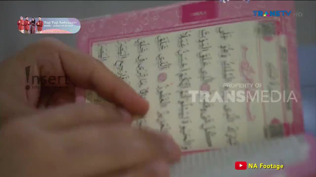 A hand turns the pages of a Quran, its delicate script filling the frame. The Trans TV logo is visible in the corner, indicating this scene is part of a broadcast.