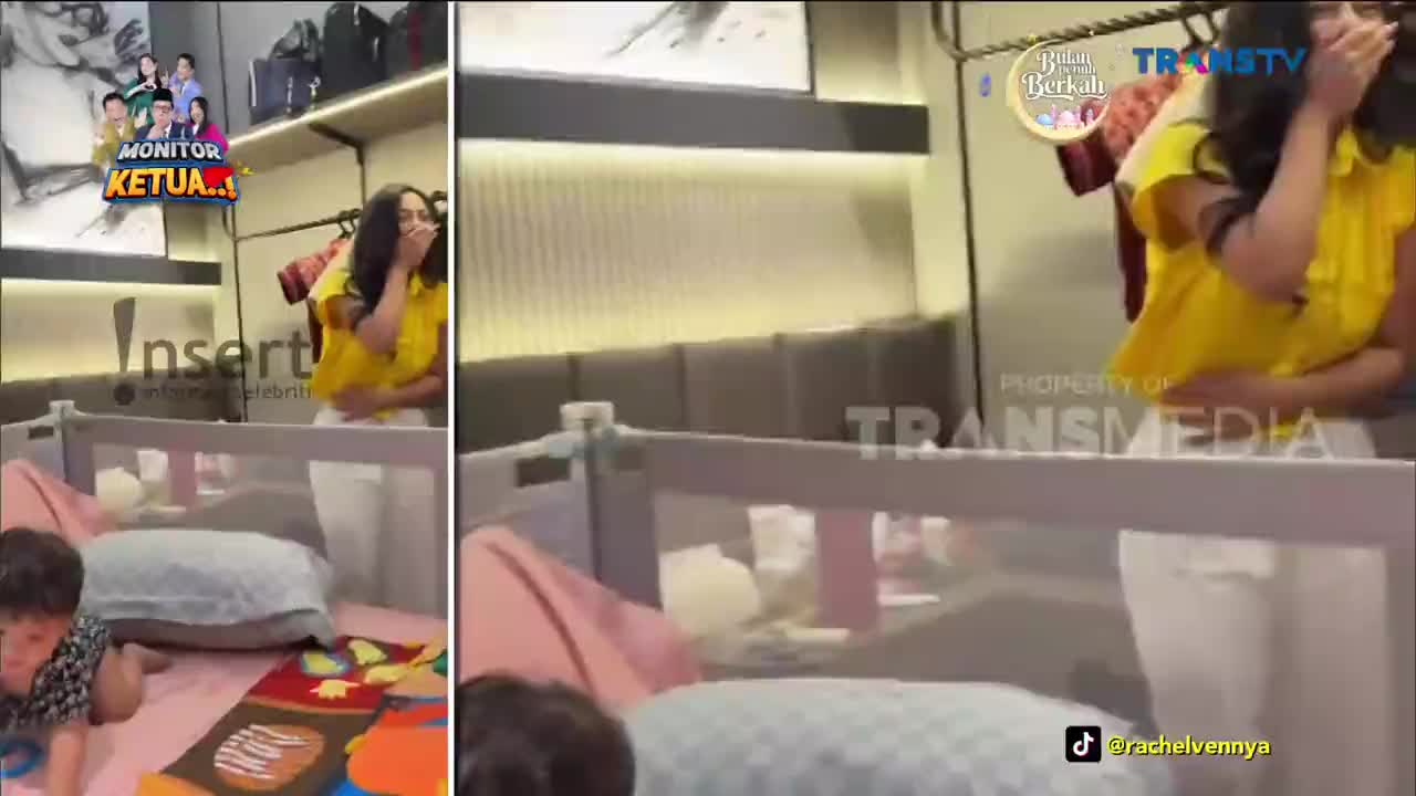 A woman in a bright yellow shirt laughs, her hand covering her mouth. A small child crawls near a crib in the foreground, while a Trans TV logo appears on screen.