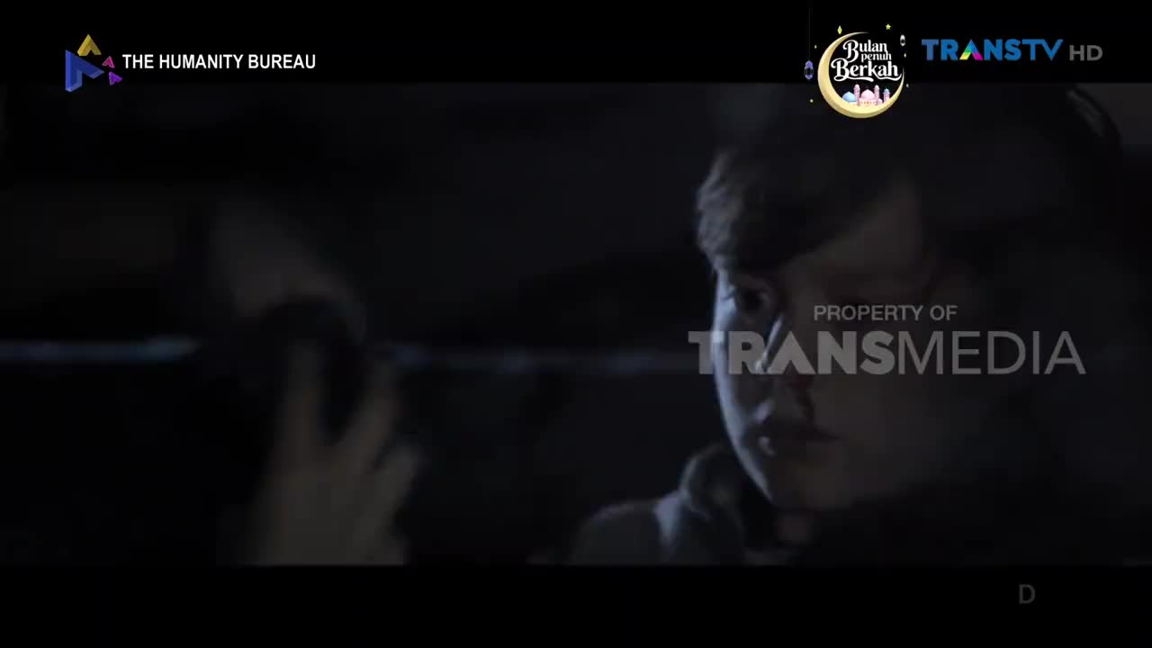 A young person's face, lit from the side, fills the right of the screen. Their eyes are wide, looking slightly past the camera.