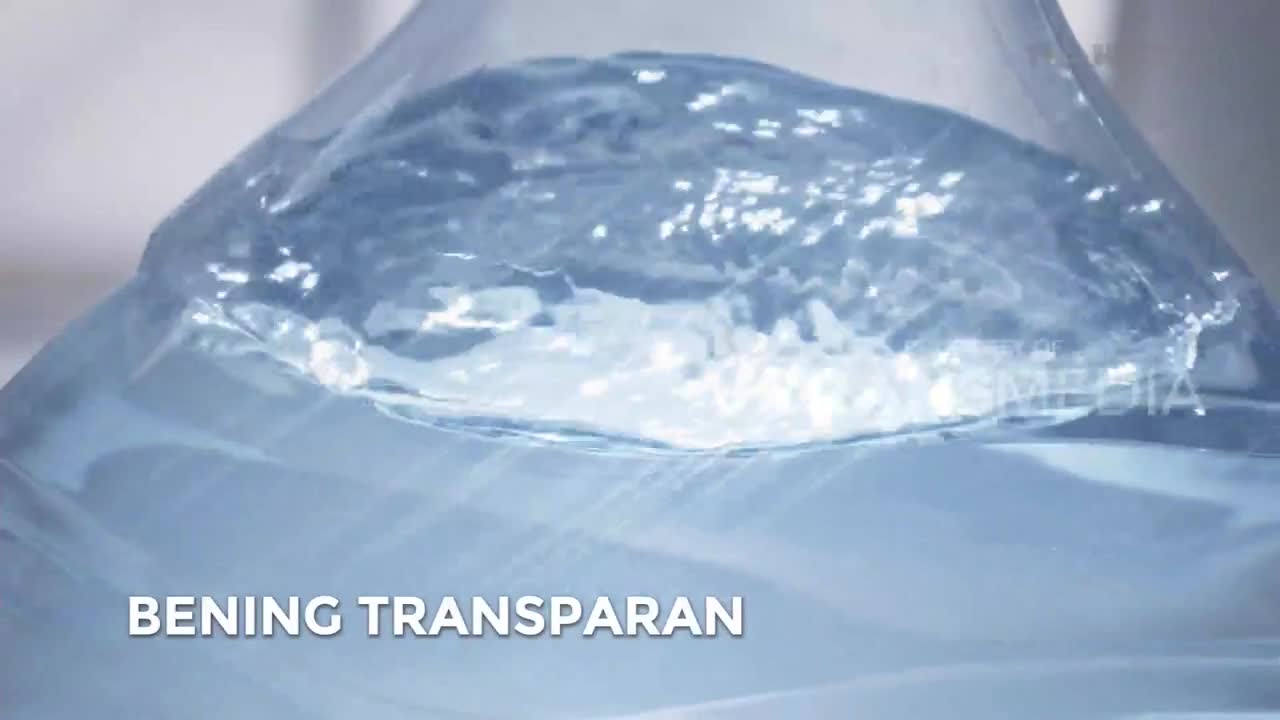 The water in this large bottle is sloshing, creating a foamy crest. A Trans TV logo is visible on the plastic.